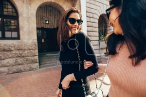 Best friends walking together in city